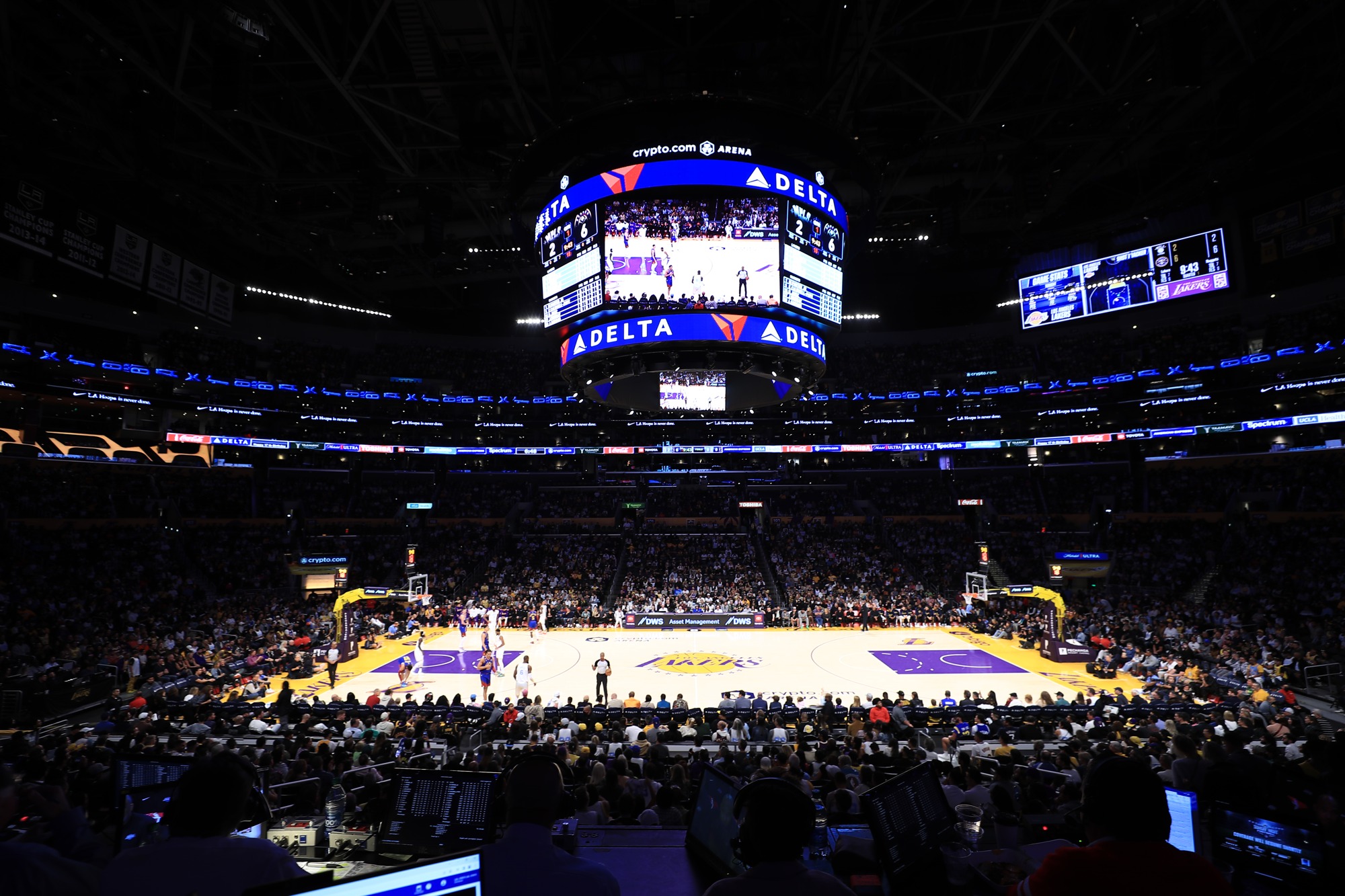 Actual Delta advertising visible on arena displays during a basketball game