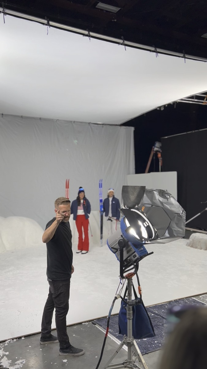 Behind-the-scenes view of the photography set, lights and crew