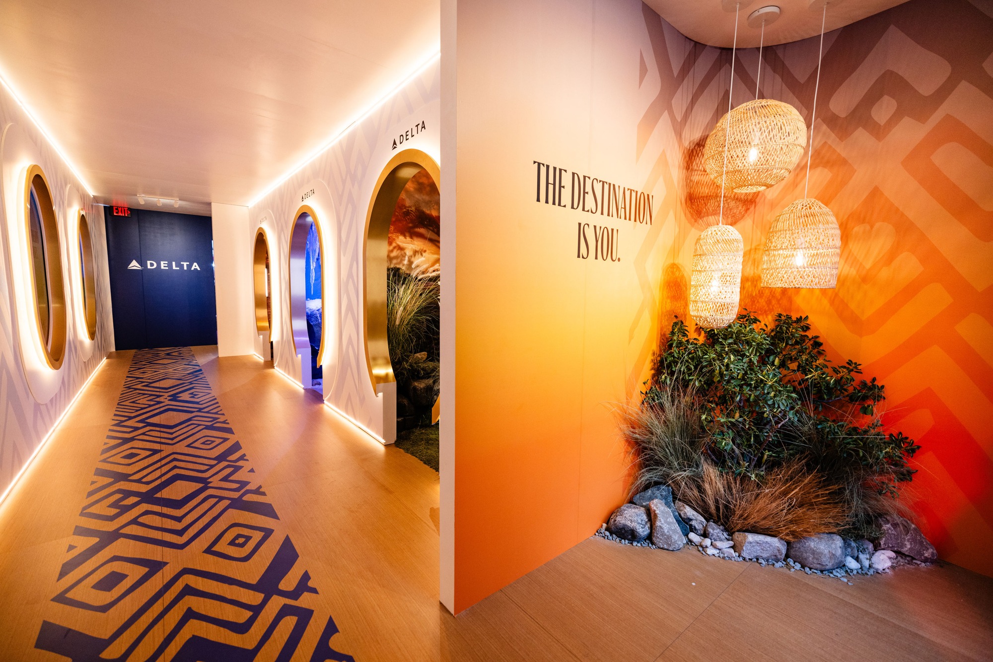 Warmly lit Delta Mufasa premiere environment with aircraft window installations