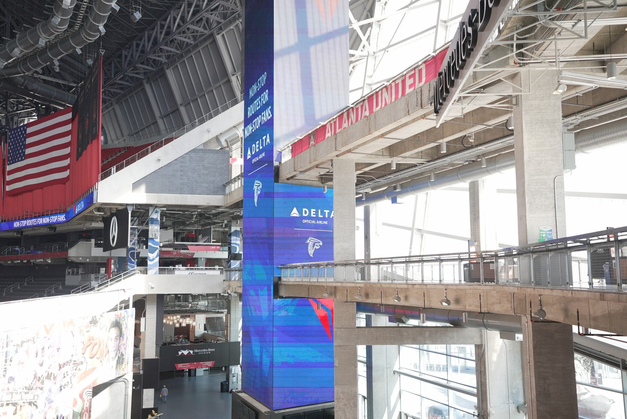 Delta LED mega-column seen in a stadium concourse